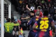 Bayern's Thomas Mueller (top R) heads the ball during their Champions League match against Barcelona on May 1, 2013